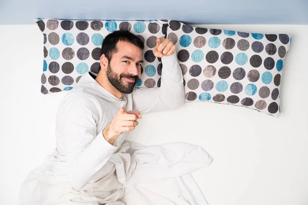 Happy Man in bed in top view
