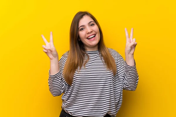 Young Girl Yellow Wall Showing Victory Sign Both Hands — ストック写真