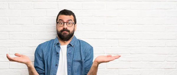 Handsome Man Beard White Brick Wall Having Doubts While Raising — Stock Photo, Image