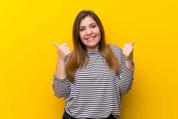 Young Girl Yellow Wall Thumbs Gesture Smiling — 스톡 사진