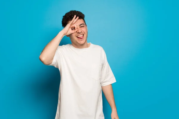 Young Man Blue Background Makes Funny Crazy Face Emotion — Stock Photo, Image