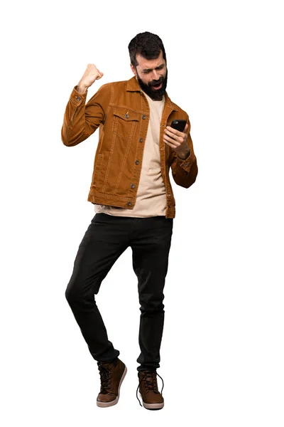 Bonito Homem Com Barba Com Telefone Posição Vitória Sobre Fundo — Fotografia de Stock