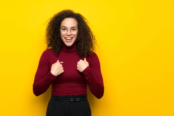 Dominican woman with turtleneck sweater with surprise facial expression