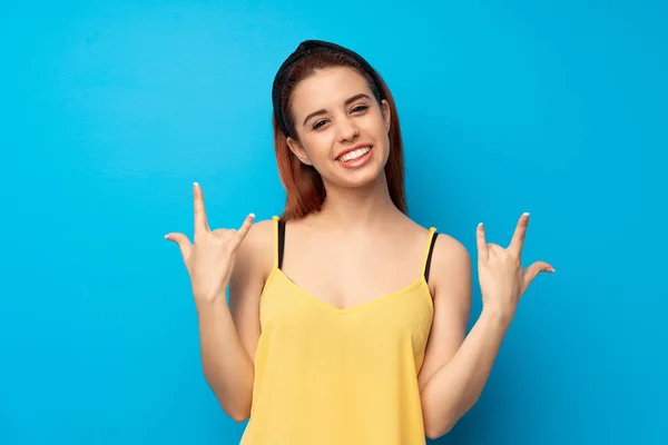 Young Redhead Woman Blue Background Making Rock Gesture — Stock Photo, Image