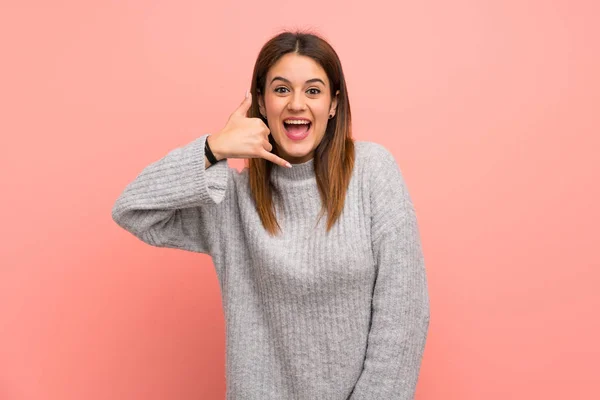 Young Woman Pink Wall Making Phone Gesture Call Back Sign — 스톡 사진