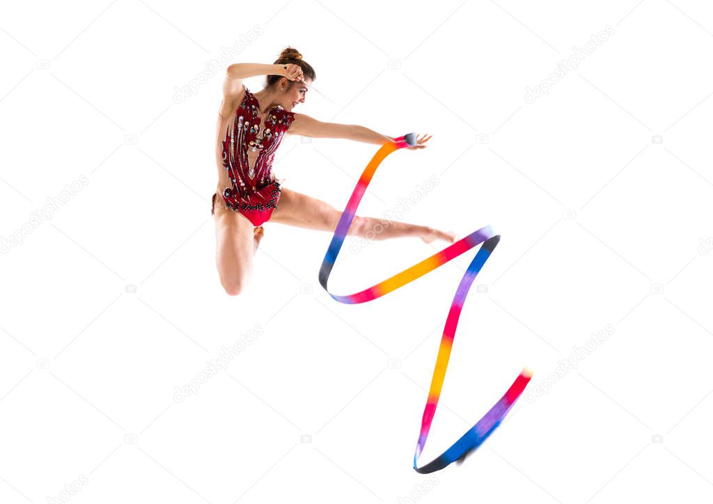 Girl doing rhythmic gymnastics with ribbon jumping