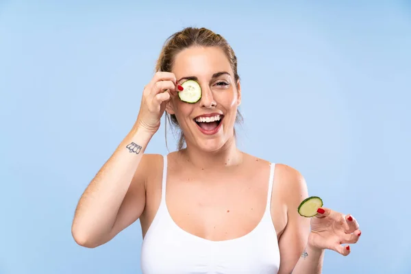 Feliz hermosa mujer joven sosteniendo rebanadas de pepino — Foto de Stock