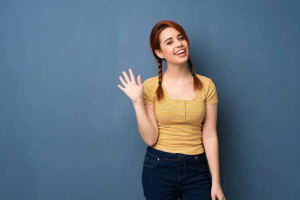 Young Redhead Woman Blue Background Saluting Hand Happy Expression — Stock Photo, Image