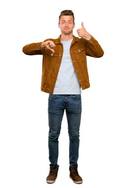 Sarışın yakışıklı adam iyi-kötü işareti yapıyor. Evet ya da değil arasında kararsız