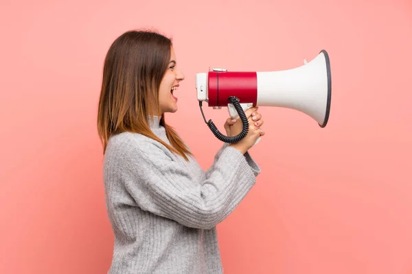 stock image Young woman over pink wall shouting through a megaphone
