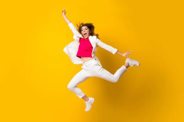 Mujer Joven Saltando Sobre Aislada Pared Amarilla Haciendo Gesto Victoria —  Fotos de Stock