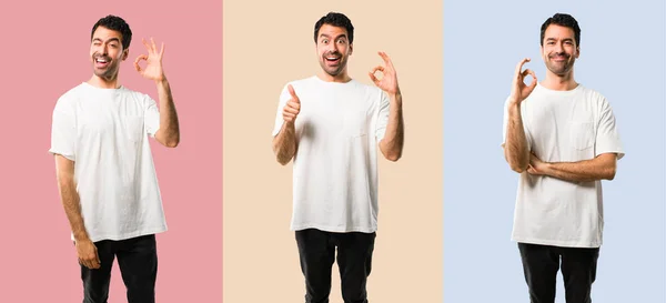 Set med ung man med vit skjorta som visar en OK skylt med fingret — Stockfoto