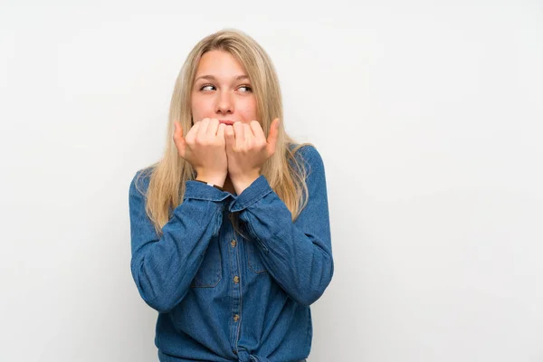 Young Blonde Woman Isolated White Wall Nervous Scared Putting Hands — Stockfoto