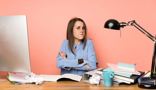 Young student girl making doubts gesture while lifting the shoulders