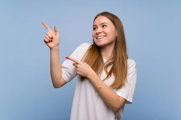 Young Woman Blue Wall Pointing Index Finger Looking — Stock Photo, Image