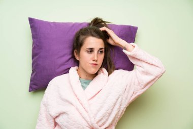 Pijamalı genç kadın düşünüyor.