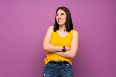 Aşırı izole olmuş genç bir kadın gülümserken yukarı bakıyor.