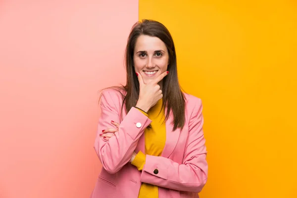 Young Woman Pink Suit Colorful Background Laughing — Stockfoto