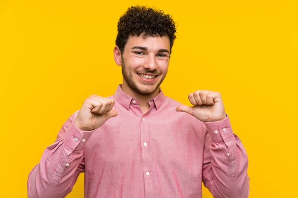 Man Curly Hair Isolated Yellow Wall Proud Self Satisfied — Stock Photo, Image