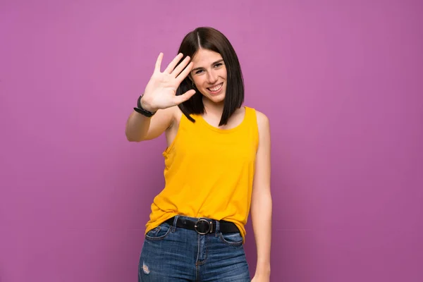 Young Woman Isolated Purple Wall Saluting Hand Happy Expression — Stock Photo, Image