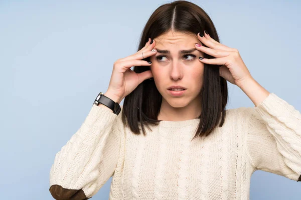 Young woman over isolated blue wall unhappy and frustrated with something. Negative facial expression