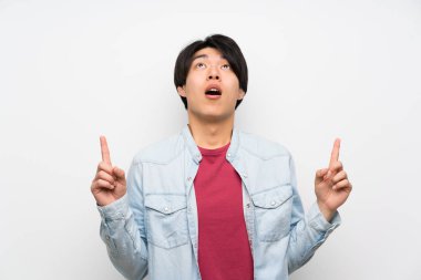 Izole beyaz arka plan asyalı adam şaşırttı ve işaret