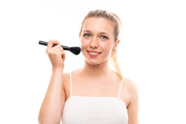 Makyaj fırçası ile izole beyaz arka plan üzerinde Genç sarışın kadın