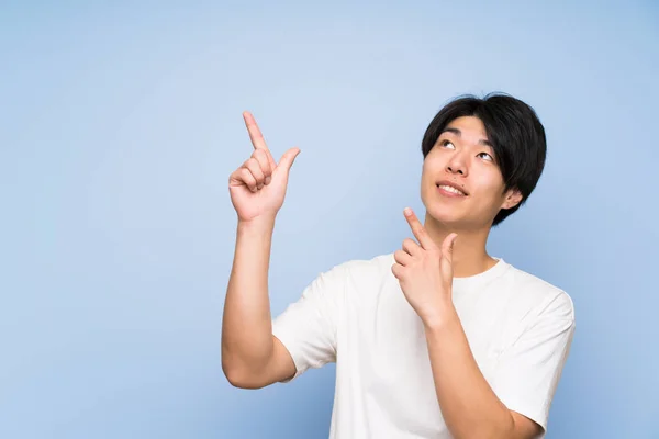 Asiatique Homme Sur Fond Bleu Isolé Pointant Avec Index Une — Photo