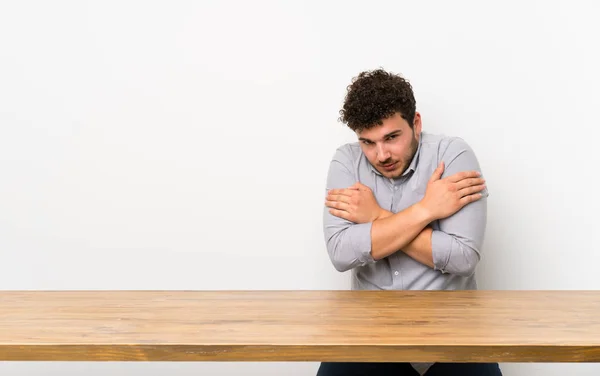 Young man with a table freezing