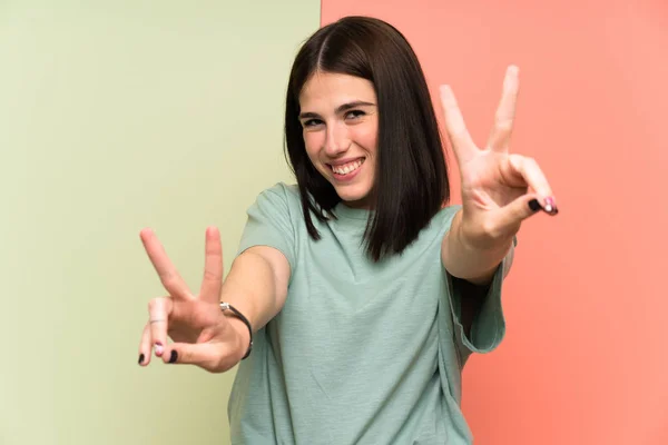 Young Woman Isolated Colorful Wall Smiling Showing Victory Sign — Stock Photo, Image