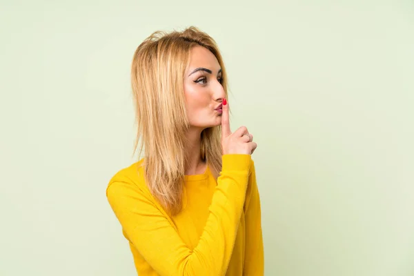 Joven Rubia Sobre Fondo Verde Aislado Haciendo Gesto Silencio —  Fotos de Stock