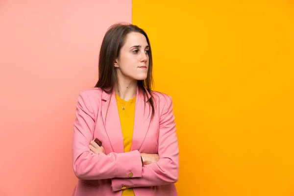 Young Woman Pink Suit Colorful Background Standing Looking Side — Stock Photo, Image
