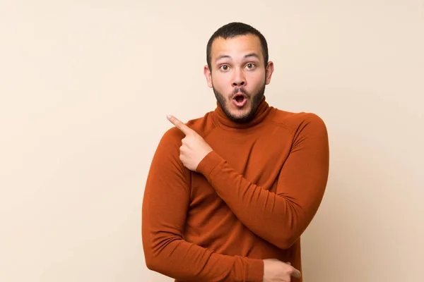 Colombian Man Turtleneck Sweater Surprised Pointing Side — Stock Photo, Image