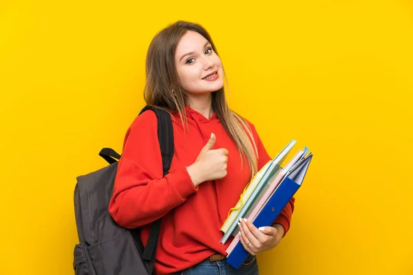 Adolescente Estudiante Chica Sobre Amarillo Fondo Dando Pulgar Hacia Arriba —  Fotos de Stock