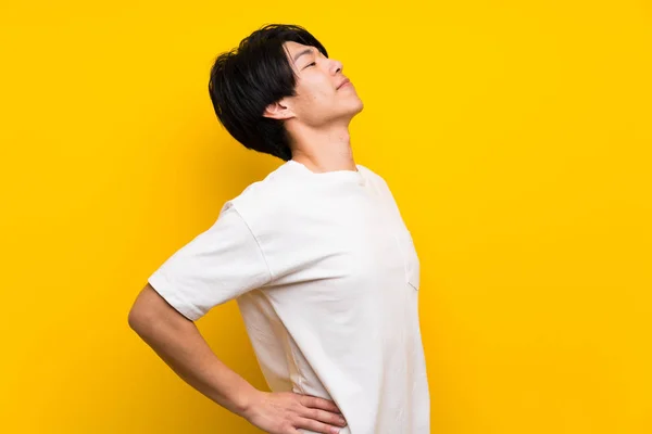 Asian Man Isolated Yellow Wall Suffering Backache Having Made Effort — Stock Photo, Image