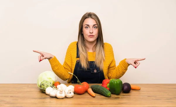 Woman Lots Vegetables Pointing Laterals Having Doubts — ストック写真