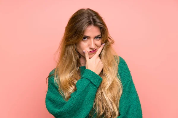 Young Blonde Woman Green Sweater Pink Wall Standing Thinking Idea — 스톡 사진