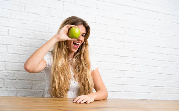 Lycklig ung blond kvinna med ett äpple — Stockfoto