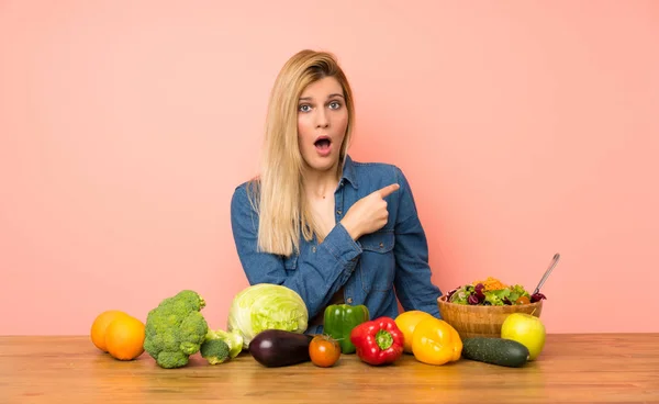 Young Blonde Woman Many Vegetables Surprised Pointing Side — Stock fotografie