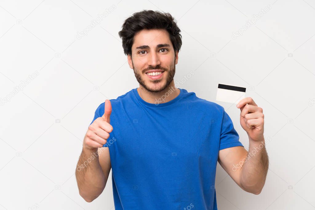 Handsome man holding a credit card