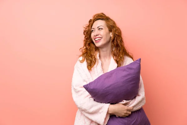 Redhead woman in dressing gown laughing