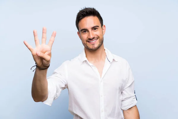 Guapo Joven Sobre Aislado Fondo Azul Feliz Contando Cuatro Con —  Fotos de Stock