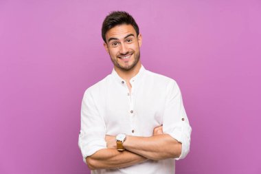 Yakışıklı genç adam üzerinde izole arka plan gülümseyen