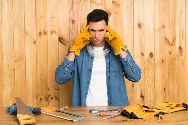 Craftsmen man over wood background unhappy and frustrated with something. Negative facial expression