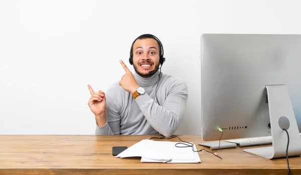 Telemarketer Colombian man frightened and pointing to the side