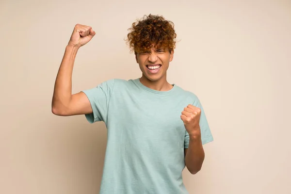 African American Man Green Shirt Celebrating Victory — Stock Photo, Image