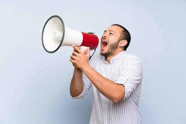 Colombian Man Isolated Blue Wall Shouting Megaphone — Stock Photo, Image