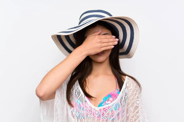 Teenager girl on summer vacation covering eyes by hands