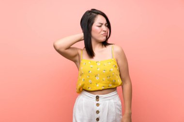 Young Mexican woman over isolated wall with neckache