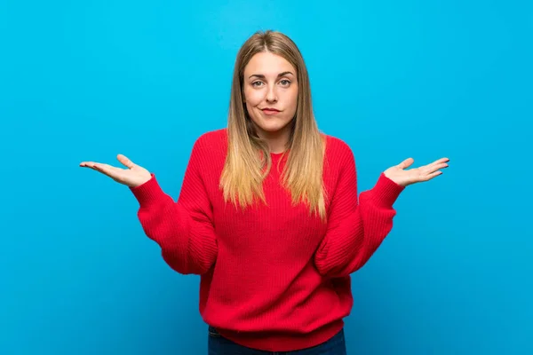 Woman Red Sweater Blue Wall Having Doubts While Raising Hands — Stock Photo, Image